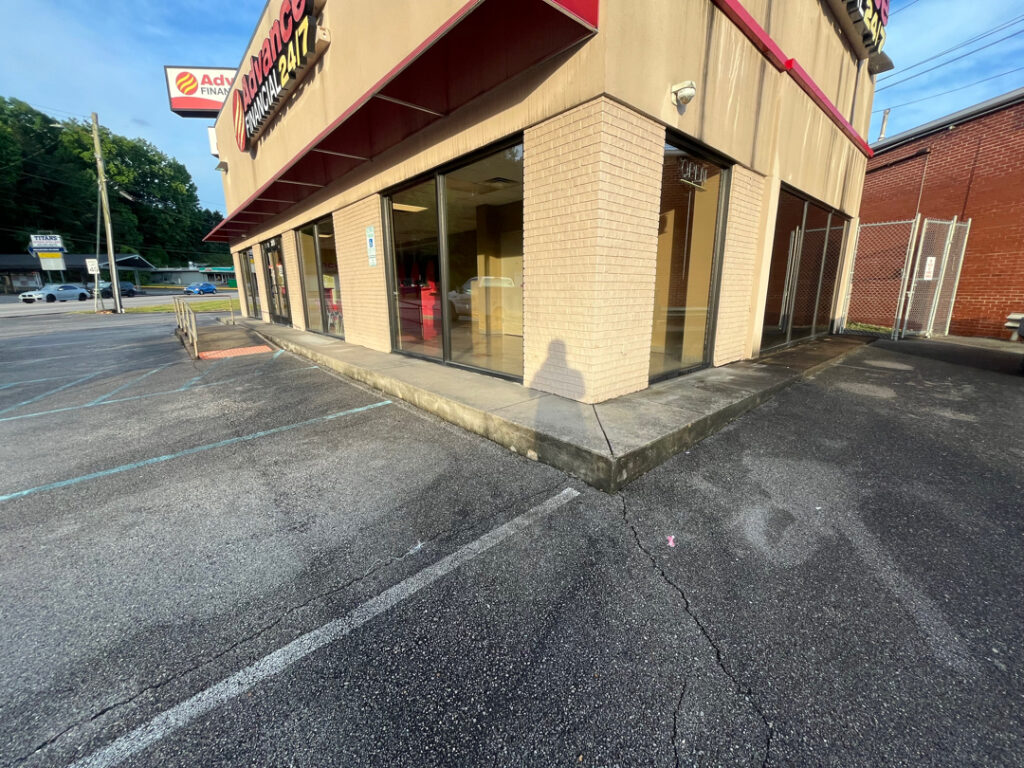 The team performed a specialized low-pressure soft wash on a commercial awning system and a professional power wash on adjacent concrete surfaces in Chattanooga to remove organic growth and restore the property's curb appeal.