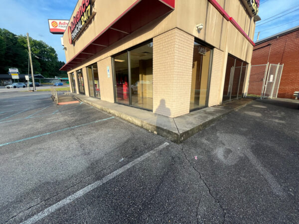 The team performed a specialized low-pressure soft wash on a commercial awning system and a professional power wash on adjacent concrete surfaces in Chattanooga to remove organic growth and restore the property's curb appeal.
