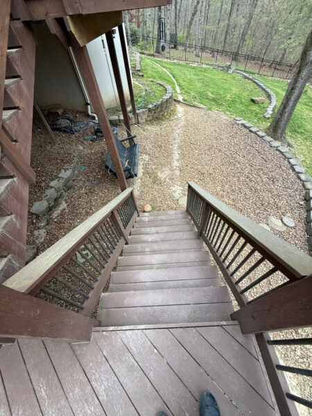 The work performed consists of soft washing and rinsing the primary structure's exterior surfaces, three rear decks, a treehouse with its decks and bridges, and surface cleaning the concrete flatwork, all backed by a one-year warranty against mold and mildew regrowth.