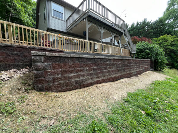 This comprehensive exterior cleaning project involved a full soft wash of the home's surfaces, a dedicated pressure wash of concrete hardscapes and retaining walls, and a gentle cleaning of the wood deck and mailbox to remove organic growth and restore the property's appearance.