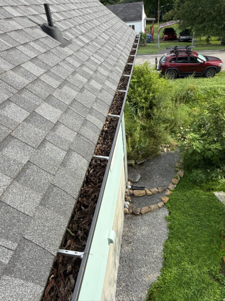 Using low-pressure soft washing methods, this project completed a full exterior refresh of a two-story home in Chattanooga, which included cleaning the house siding, front porch and back steps, washing the metal roof, and clearing and flushing the gutter system.