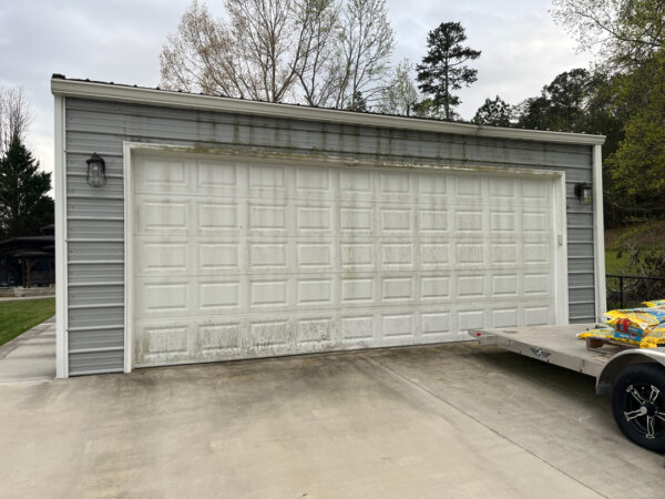 Professional soft wash exterior cleaning will be performed on the main house, porches, and three garage buildings, targeting all vertical surfaces and roofline components to remove organic growth and debris with a one-year warranty.
