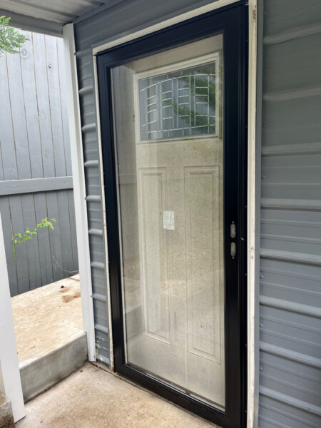 Professional soft wash exterior cleaning will be performed on the main house, porches, and three garage buildings, targeting all vertical surfaces and roofline components to remove organic growth and debris with a one-year warranty.