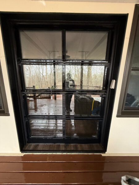 The work performed consists of soft washing and rinsing the primary structure's exterior surfaces, three rear decks, a treehouse with its decks and bridges, and surface cleaning the concrete flatwork, all backed by a one-year warranty against mold and mildew regrowth.