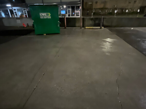 This project involved pressure washing a Chattanooga restaurant's front sidewalk, customer patio, and dumpster area using a municipal fire hydrant water source to remove dirt, stains, and grease for a cleaner appearance.