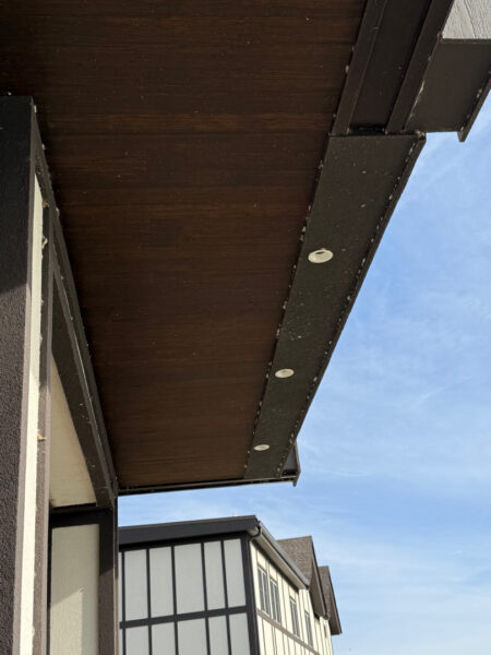 This Chattanooga project utilized surface and soft washing techniques to deep clean the rear walkway, under-deck concrete, and 1896 bar patio while specifically removing red clay stains from the chimney and retaining walls.