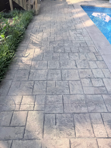 Professional cleaning and pressure washing were performed on a concrete pool deck and a retaining wall in Chattanooga to remove mold, mildew, and grime through the application of specialized detergents and methodical surface washing.