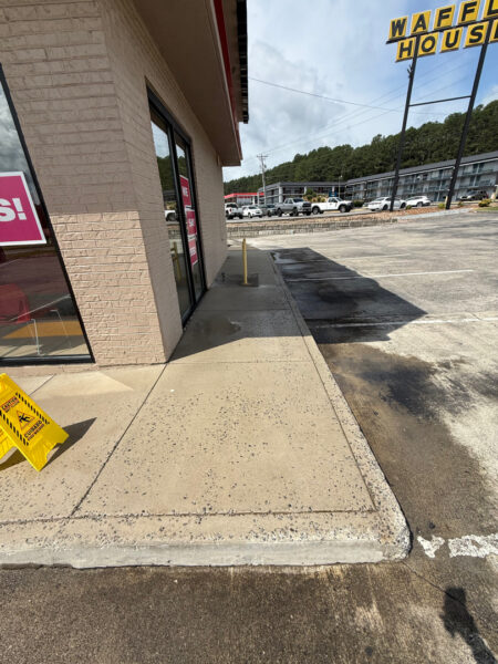 This commercial cleaning project in Cleveland utilized low-pressure soft washing to remove organic growth from the building's masonry and surface washing to refresh the surrounding concrete sidewalks.