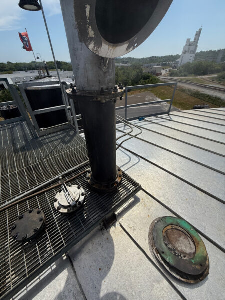 This project involved the complete cleaning and surface preparation of two industrial storage tanks' tops and upper walls using a 40-foot electric lift, pressure washing, and specialized detergents to remove mold, mildew, and dirt.