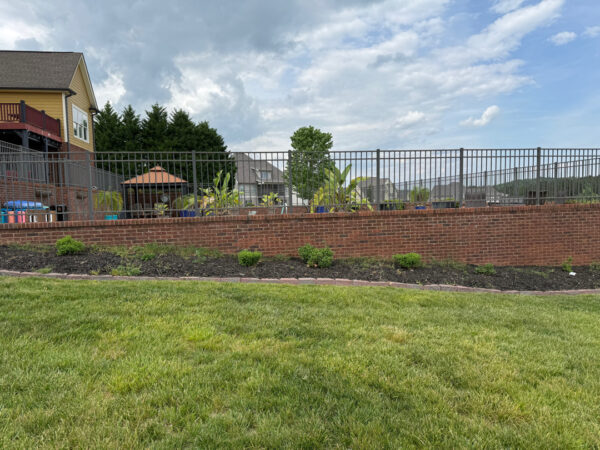 This comprehensive exterior restoration in Soddy-Daisy utilized professional soft-wash and pressure washing techniques to clean the home's siding, concrete surfaces, pool deck, three wood decks, patio furniture, retaining walls, and both interior and exterior windows.