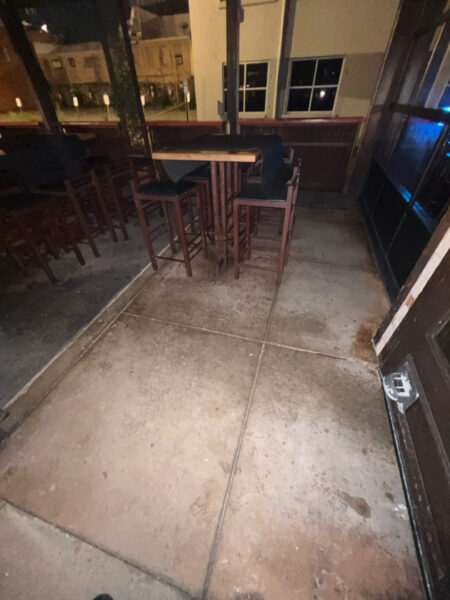 This project involved pressure washing a Chattanooga restaurant's front sidewalk, customer patio, and dumpster area using a municipal fire hydrant water source to remove dirt, stains, and grease for a cleaner appearance.