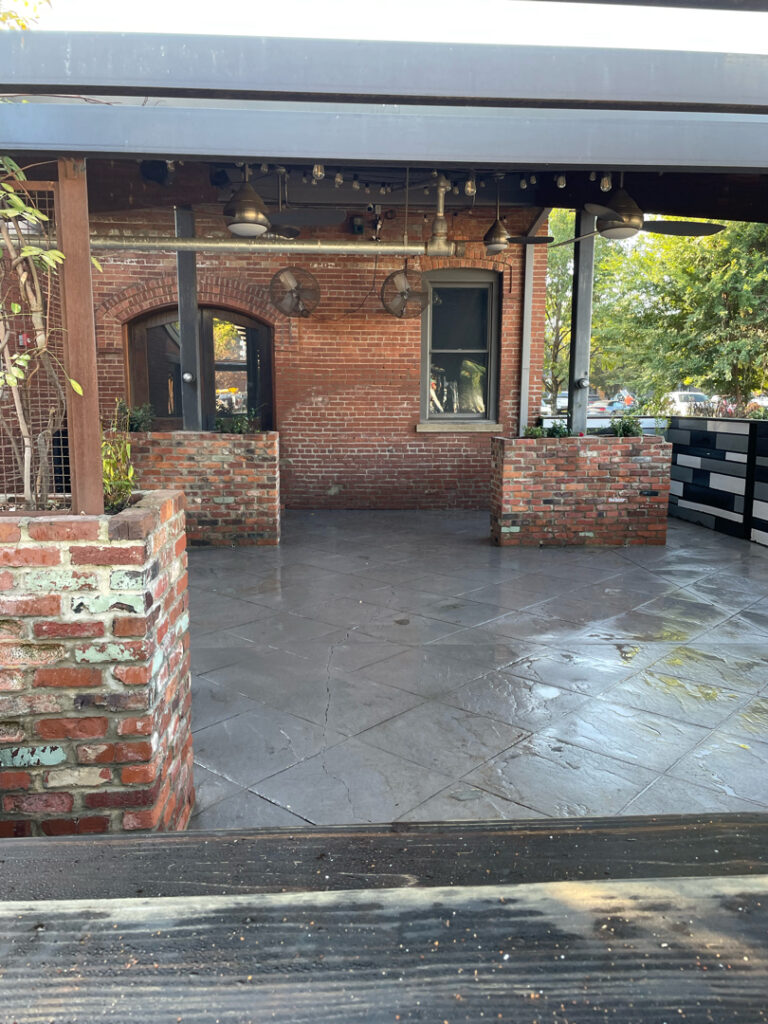 The project at Urban Stack in Chattanooga involved inspecting and thoroughly pressure washing the restaurant's exterior sidewalks, dining patios, and side entrance to remove dirt, stains, and grease, thereby restoring a clean appearance and improving pedestrian safety.