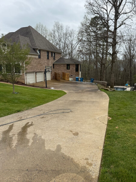 The work performed consists of soft washing and rinsing the primary structure's exterior surfaces, three rear decks, a treehouse with its decks and bridges, and surface cleaning the concrete flatwork, all backed by a one-year warranty against mold and mildew regrowth.