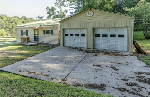 This project involved a comprehensive low-pressure soft wash of a single-story home's exterior surfaces, including siding, trim, and gutters, to remove organic growth and restore a uniform appearance.