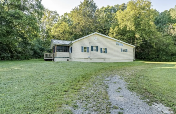 This project involved a comprehensive low-pressure soft wash of a single-story home's exterior surfaces, including siding, trim, and gutters, to remove organic growth and restore a uniform appearance.