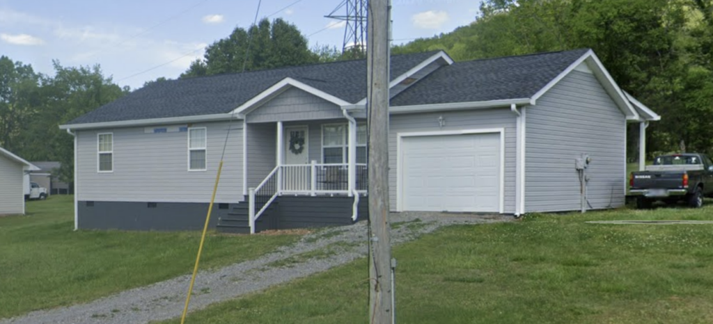 This project involved a comprehensive soft wash exterior cleaning of a one-story home in Powells Crossroads, including the upper trim, siding, front porch, and wood deck, to safely remove organic growth and dirt with a one-year warranty.