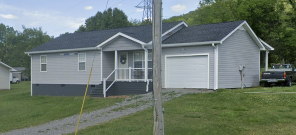 This project involved a comprehensive soft wash exterior cleaning of a one-story home in Powells Crossroads, including the upper trim, siding, front porch, and wood deck, to safely remove organic growth and dirt with a one-year warranty.