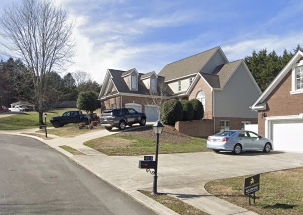 This project involved a comprehensive soft wash and gentle scrubbing of a two-story home's exterior, front steps, retaining wall, and covered back porch in Apison to remove organic buildup and grime, backed by a 1-year mold and mildew warranty.