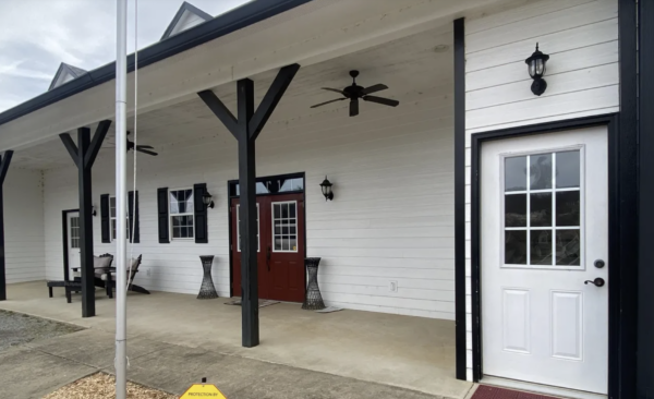 This project involved a complete exterior soft wash of a one-story barndominium in Collegedale, including its walls, dormers, covered porches, and trim, utilizing low-pressure cleaning and detergents to remove organic growth and dirt with a one-year warranty.