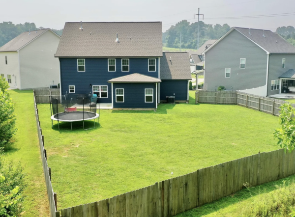 A two-story home in Cleveland, TN, received a comprehensive soft wash cleaning of its vertical surfaces, gutters, and trim, backed by a one-year warranty against mold and mildew regrowth.