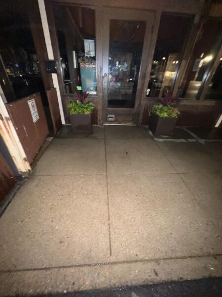 This project involved pressure washing a Chattanooga restaurant's front sidewalk, customer patio, and dumpster area using a municipal fire hydrant water source to remove dirt, stains, and grease for a cleaner appearance.