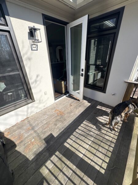 The work performed consists of soft washing and rinsing the primary structure's exterior surfaces, three rear decks, a treehouse with its decks and bridges, and surface cleaning the concrete flatwork, all backed by a one-year warranty against mold and mildew regrowth.