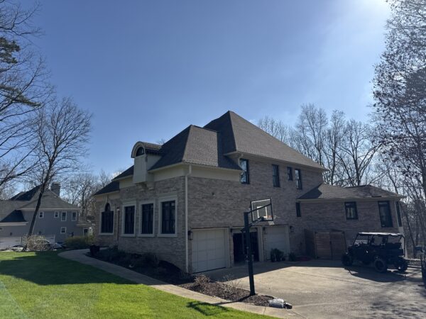 The work performed consists of soft washing and rinsing the primary structure's exterior surfaces, three rear decks, a treehouse with its decks and bridges, and surface cleaning the concrete flatwork, all backed by a one-year warranty against mold and mildew regrowth.