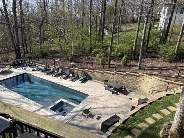 The work performed consists of soft washing and rinsing the primary structure's exterior surfaces, three rear decks, a treehouse with its decks and bridges, and surface cleaning the concrete flatwork, all backed by a one-year warranty against mold and mildew regrowth.