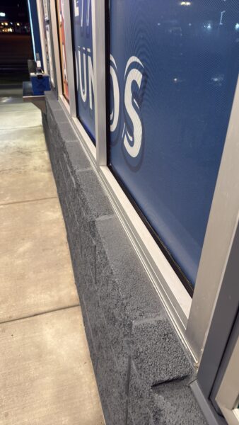 This commercial building in Chattanooga receives a biannual, low-pressure soft wash treatment to remove organic growth and debris from its masonry facade while preserving the integrity of the structure.