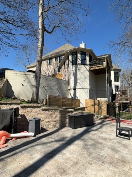 The work performed consists of soft washing and rinsing the primary structure's exterior surfaces, three rear decks, a treehouse with its decks and bridges, and surface cleaning the concrete flatwork, all backed by a one-year warranty against mold and mildew regrowth.
