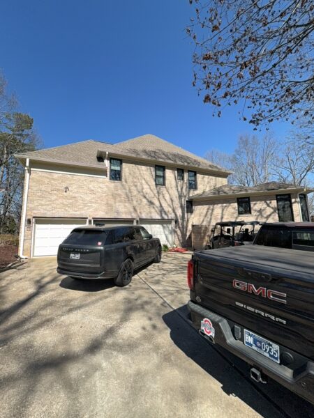 The work performed consists of soft washing and rinsing the primary structure's exterior surfaces, three rear decks, a treehouse with its decks and bridges, and surface cleaning the concrete flatwork, all backed by a one-year warranty against mold and mildew regrowth.