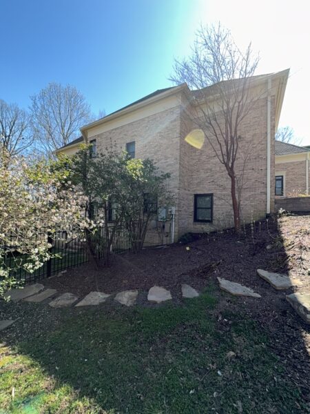 The work performed consists of soft washing and rinsing the primary structure's exterior surfaces, three rear decks, a treehouse with its decks and bridges, and surface cleaning the concrete flatwork, all backed by a one-year warranty against mold and mildew regrowth.