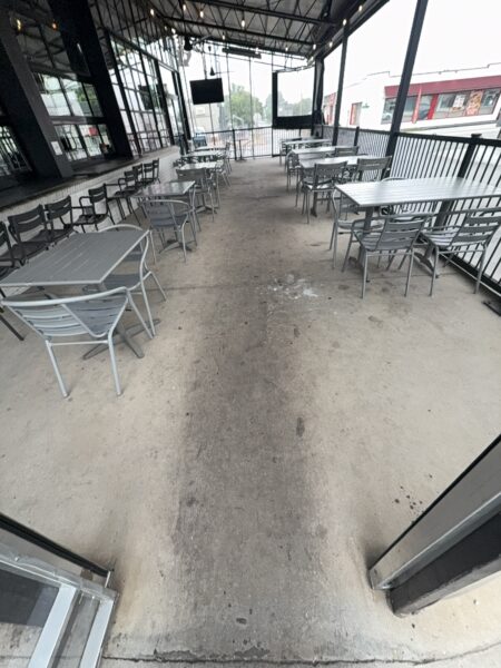 This commercial concrete power washing project in Chattanooga involved clearing the outdoor patio, treating and washing the concrete surface and handrails with specialized detergents to remove organic buildup and grime, and restoring the furniture to its original layout for immediate use.