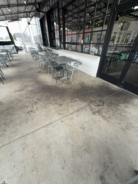 This commercial concrete power washing project in Chattanooga involved clearing the outdoor patio, treating and washing the concrete surface and handrails with specialized detergents to remove organic buildup and grime, and restoring the furniture to its original layout for immediate use.