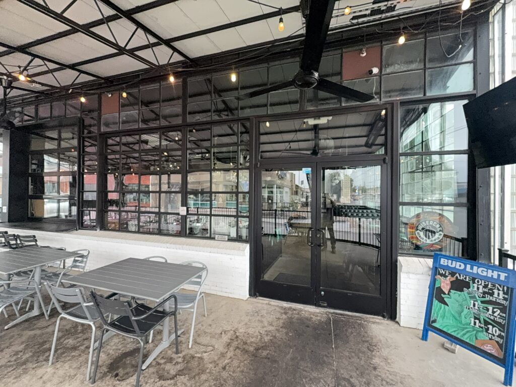 This commercial concrete power washing project in Chattanooga involved clearing the outdoor patio, treating and washing the concrete surface and handrails with specialized detergents to remove organic buildup and grime, and restoring the furniture to its original layout for immediate use.