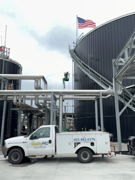 This project involved the complete cleaning and surface preparation of two industrial storage tanks' tops and upper walls using a 40-foot electric lift, pressure washing, and specialized detergents to remove mold, mildew, and dirt.