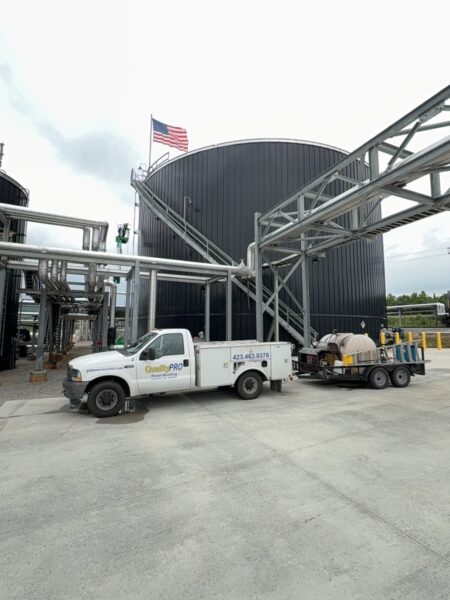 This project involved the complete cleaning and surface preparation of two industrial storage tanks' tops and upper walls using a 40-foot electric lift, pressure washing, and specialized detergents to remove mold, mildew, and dirt.