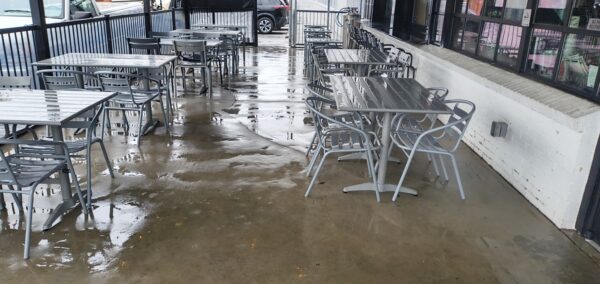 This commercial concrete power washing project in Chattanooga involved clearing the outdoor patio, treating and washing the concrete surface and handrails with specialized detergents to remove organic buildup and grime, and restoring the furniture to its original layout for immediate use.