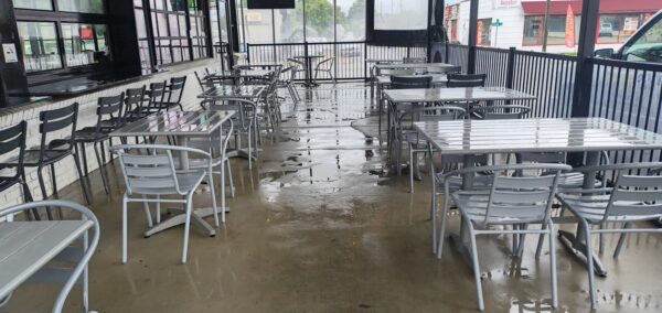 This commercial concrete power washing project in Chattanooga involved clearing the outdoor patio, treating and washing the concrete surface and handrails with specialized detergents to remove organic buildup and grime, and restoring the furniture to its original layout for immediate use.