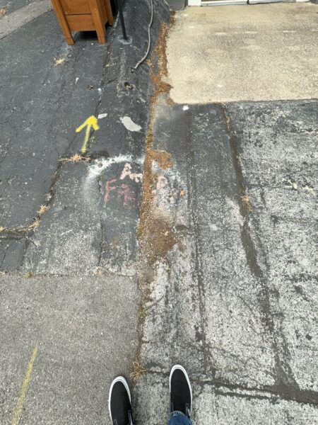 This project involved an after-hours exterior cleanup of a commercial parking area in Chattanooga, which included removing leaf debris and weeds, pressure washing concrete surfaces with detergents to eliminate mold and grime, and applying specialized treatments to remove black spray paint from concrete pads and steps.