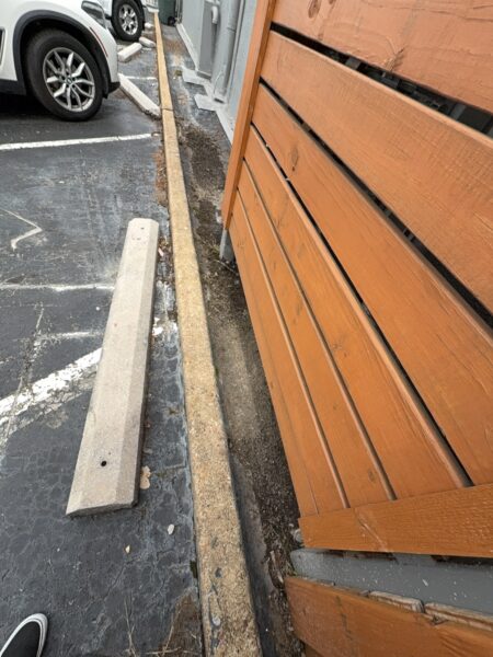 This project involved an after-hours exterior cleanup of a commercial parking area in Chattanooga, which included removing leaf debris and weeds, pressure washing concrete surfaces with detergents to eliminate mold and grime, and applying specialized treatments to remove black spray paint from concrete pads and steps.
