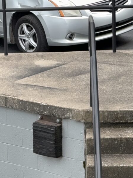 This project involved an after-hours exterior cleanup of a commercial parking area in Chattanooga, which included removing leaf debris and weeds, pressure washing concrete surfaces with detergents to eliminate mold and grime, and applying specialized treatments to remove black spray paint from concrete pads and steps.