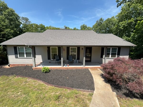 This comprehensive exterior cleaning project involved a full soft wash of the home's surfaces, a dedicated pressure wash of concrete hardscapes and retaining walls, and a gentle cleaning of the wood deck and mailbox to remove organic growth and restore the property's appearance.