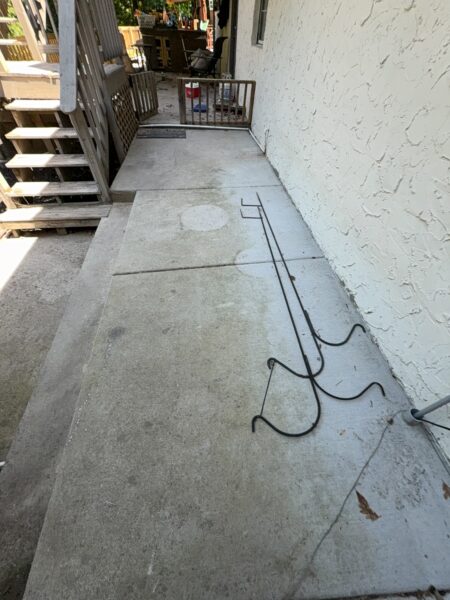 This comprehensive exterior cleaning project involved a full soft wash of the home's surfaces, a dedicated pressure wash of concrete hardscapes and retaining walls, and a gentle cleaning of the wood deck and mailbox to remove organic growth and restore the property's appearance.