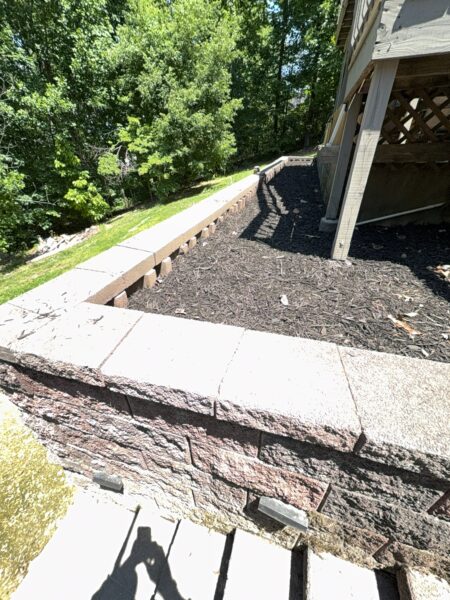 This comprehensive exterior cleaning project involved a full soft wash of the home's surfaces, a dedicated pressure wash of concrete hardscapes and retaining walls, and a gentle cleaning of the wood deck and mailbox to remove organic growth and restore the property's appearance.