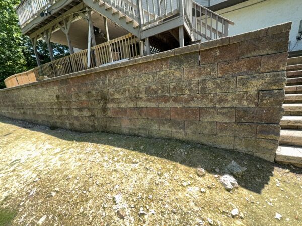 This comprehensive exterior cleaning project involved a full soft wash of the home's surfaces, a dedicated pressure wash of concrete hardscapes and retaining walls, and a gentle cleaning of the wood deck and mailbox to remove organic growth and restore the property's appearance.