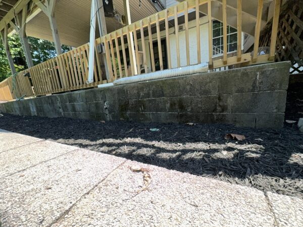This comprehensive exterior cleaning project involved a full soft wash of the home's surfaces, a dedicated pressure wash of concrete hardscapes and retaining walls, and a gentle cleaning of the wood deck and mailbox to remove organic growth and restore the property's appearance.