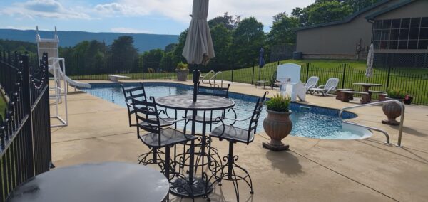 This concrete washing project in Chickamauga restored a home's pool deck and connecting walkway by applying a surface-safe detergent and using even-pressure surface washing to remove mold, mildew, and grime.