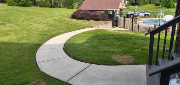 This concrete washing project in Chickamauga restored a home's pool deck and connecting walkway by applying a surface-safe detergent and using even-pressure surface washing to remove mold, mildew, and grime.