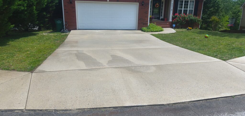 This concrete cleaning project in Ooltewah involved a specialized oil stain treatment and a comprehensive surface detergent wash to remove organic buildup and restore the driveway's appearance.